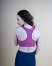 back view of a mum wearing a pink nursing sports bra with racerback & fig tank
